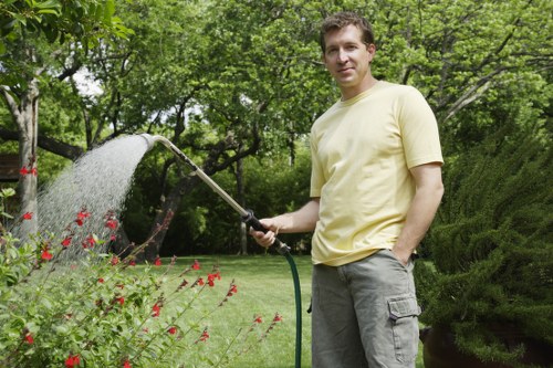 Gardener trimming hedges during spring in Waterloo