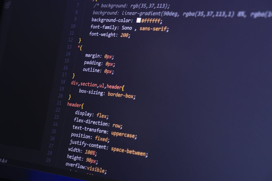A person standing in a dimly lit environment, with their face and upper body illuminated by red binary code projections. The digital numbers cascade across their features, casting a glow against the s